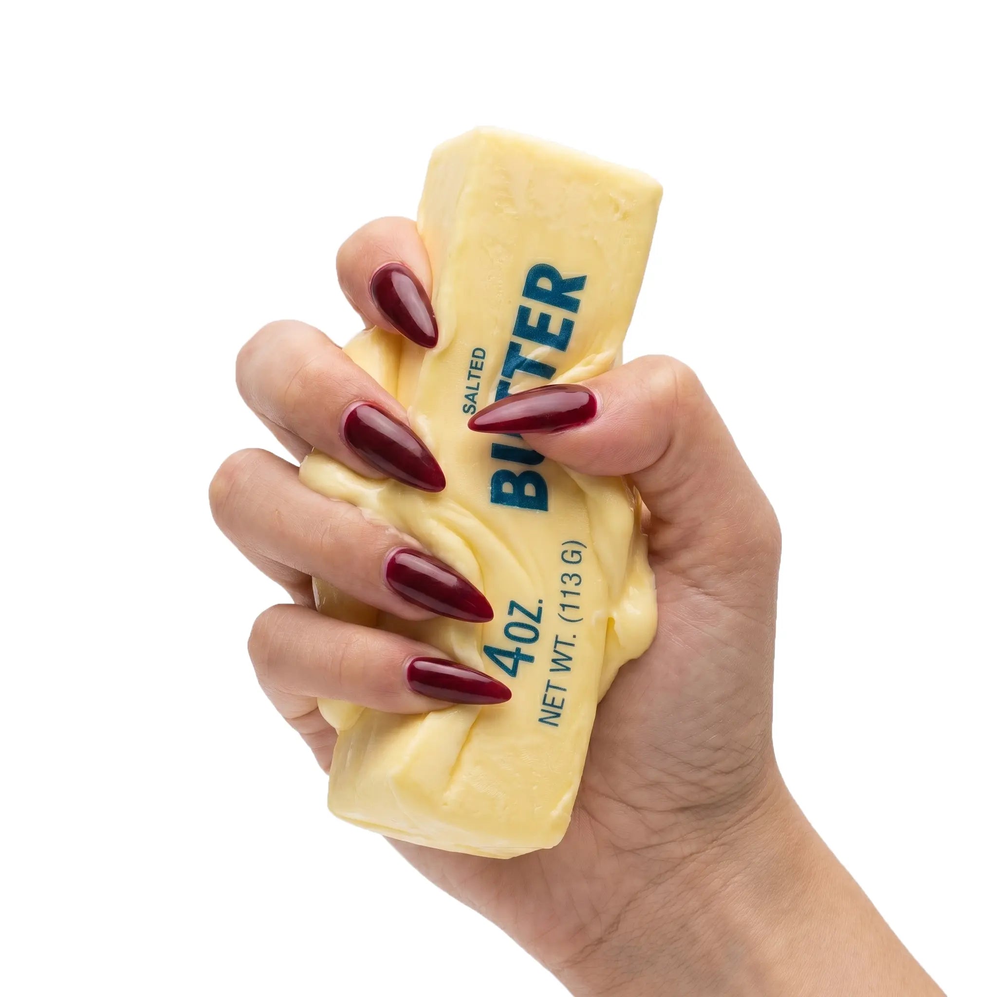 Hands squeezing a soft butter stick squishy stress ball by MimiSquishy