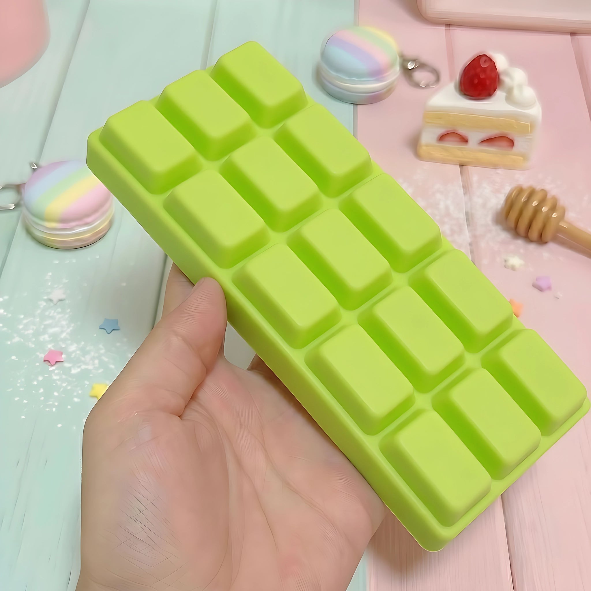 Green chocolate bar squishy displayed on a light wooden surface surrounded by accessories