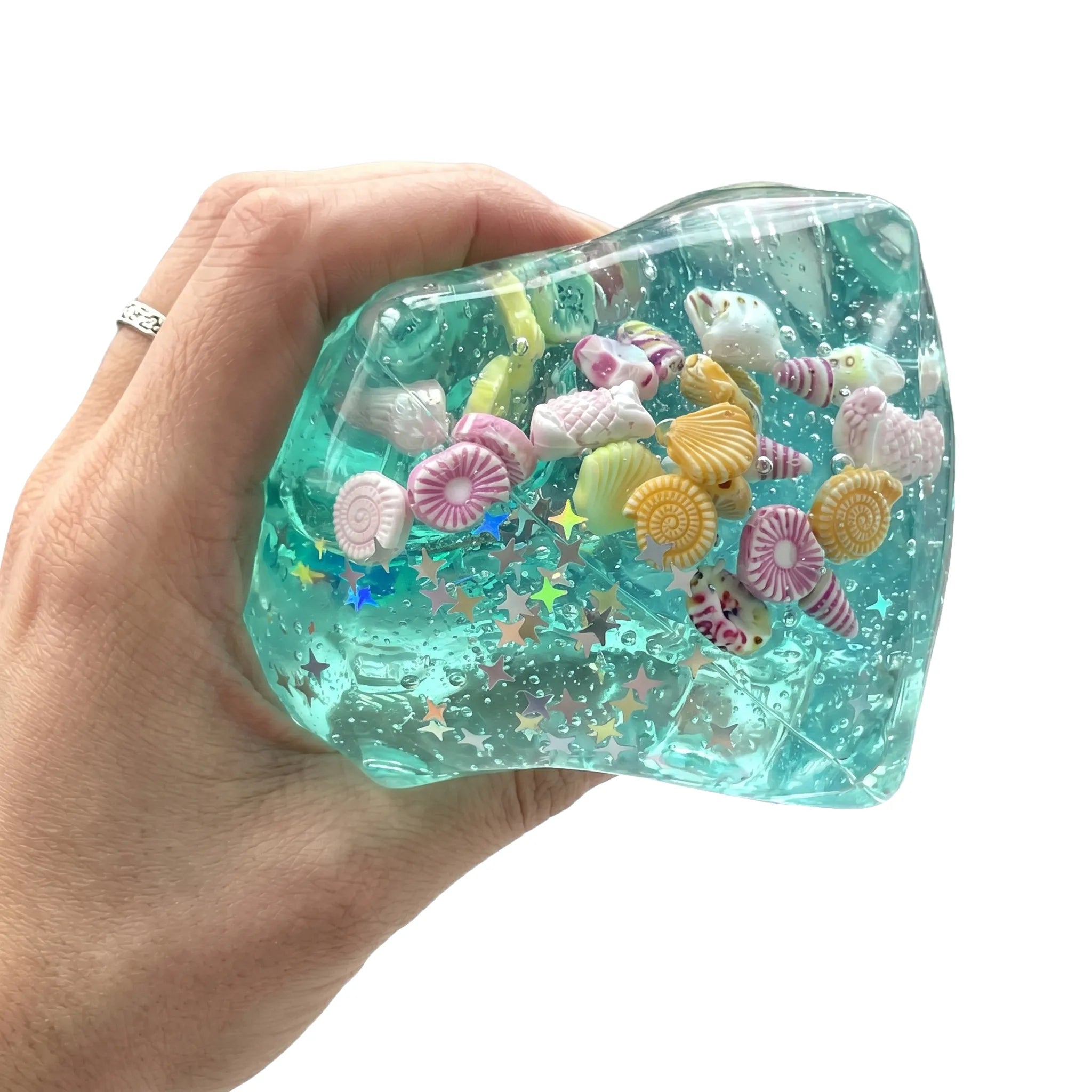 Ocean cube squishy toy being pressed and squeezed showing sea life inside on white background by MimiSquishy