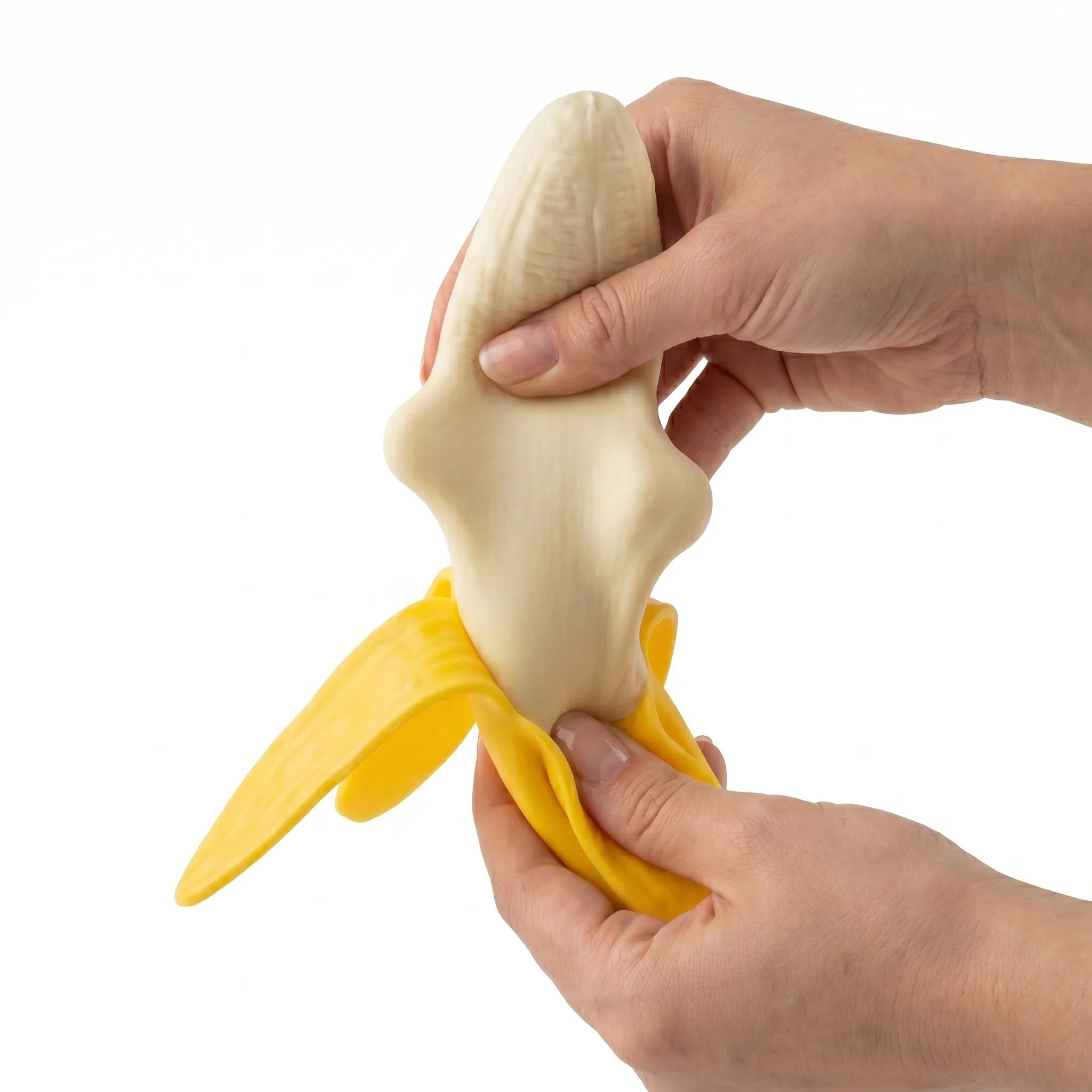Peeled banana squishy toy being pressed and squeezed on white background by MimiSquishy