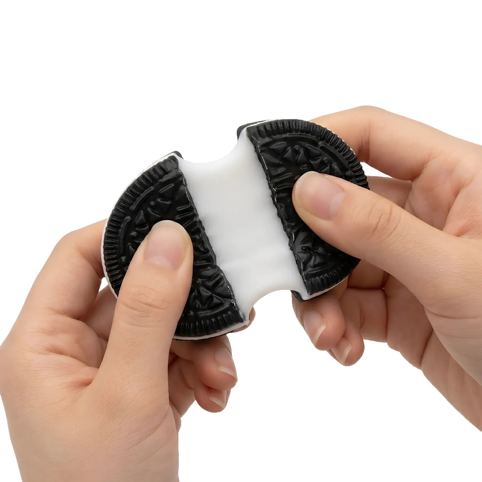Hands squeezing a soft sticky black cookie squishy toy by MimiSquishy